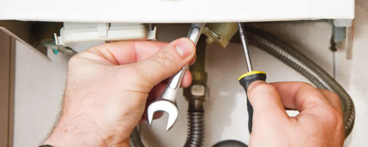 Boiler repair technician tightening pipe fittings and connections in Easton, PA