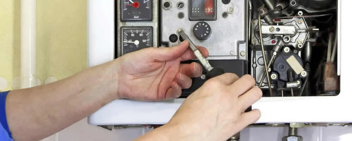 Heating repair technician adjusting boiler controls and components in Easton, PA