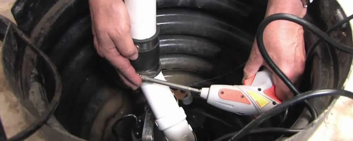 Sump pump installation technician connecting PVC discharge piping in Easton, PA